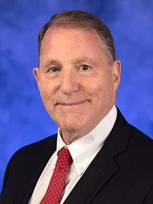 Kenneth Wood pictured in a professional head and shoulders photograph.